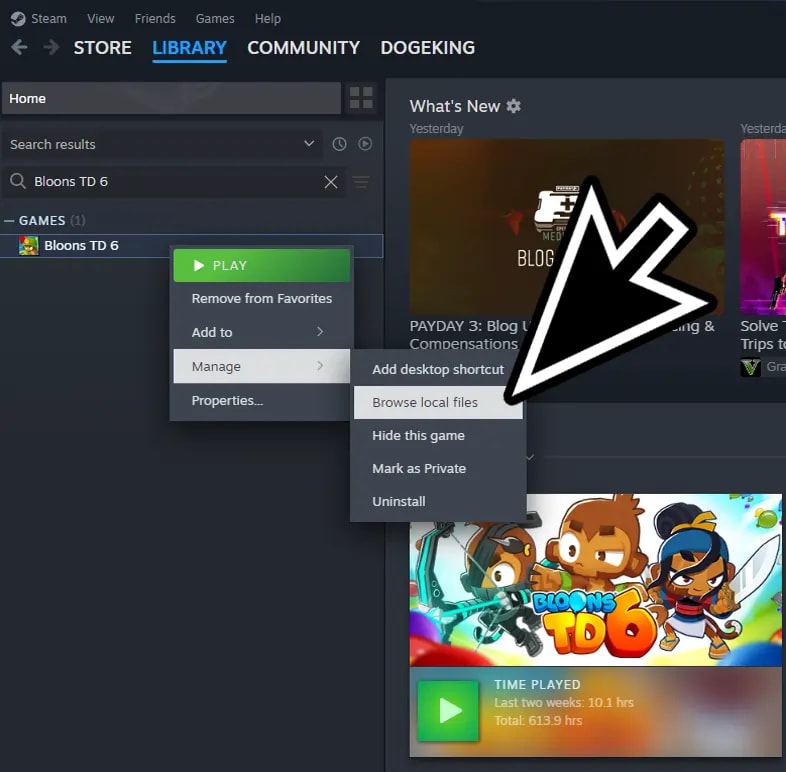 Steam library interface with a cursor hovering over the 'Browse local files' option for Bloons TD 6, essential step for accessing game files to install mods.