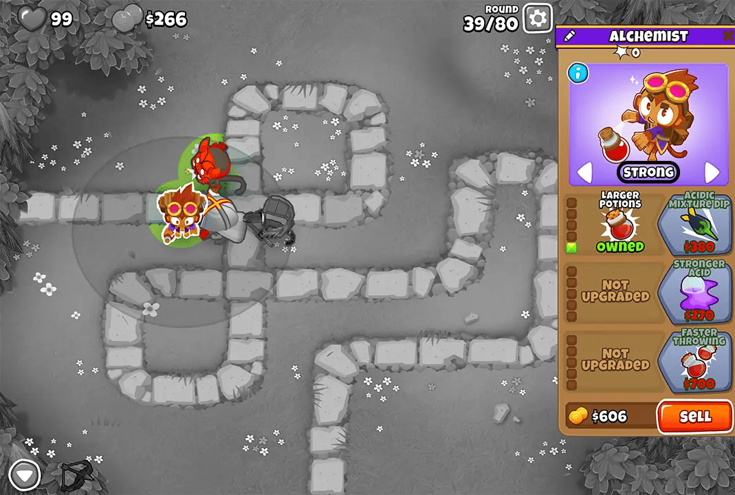 Bloons TD 6 screenshot of Round 39 on Monkey Meadow for Double HP MOABs mode. The Alchemist, selected and upgraded with Larger Potions, is visible. Nearby are a Heli Pilot and Quincy, all working together to stop the bloons.