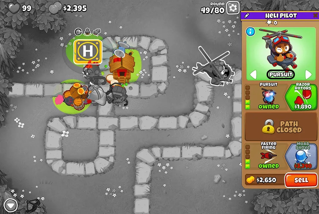 Bloons TD 6 screenshot of Round 49 on Monkey Meadow for Double HP MOABs mode. The Heli Pilot, selected and upgraded with Pursuit and Razor Rotors, is positioned centrally. Also visible are Quincy, Boomerang Monkey, and Alchemist, all defending against the bloons.