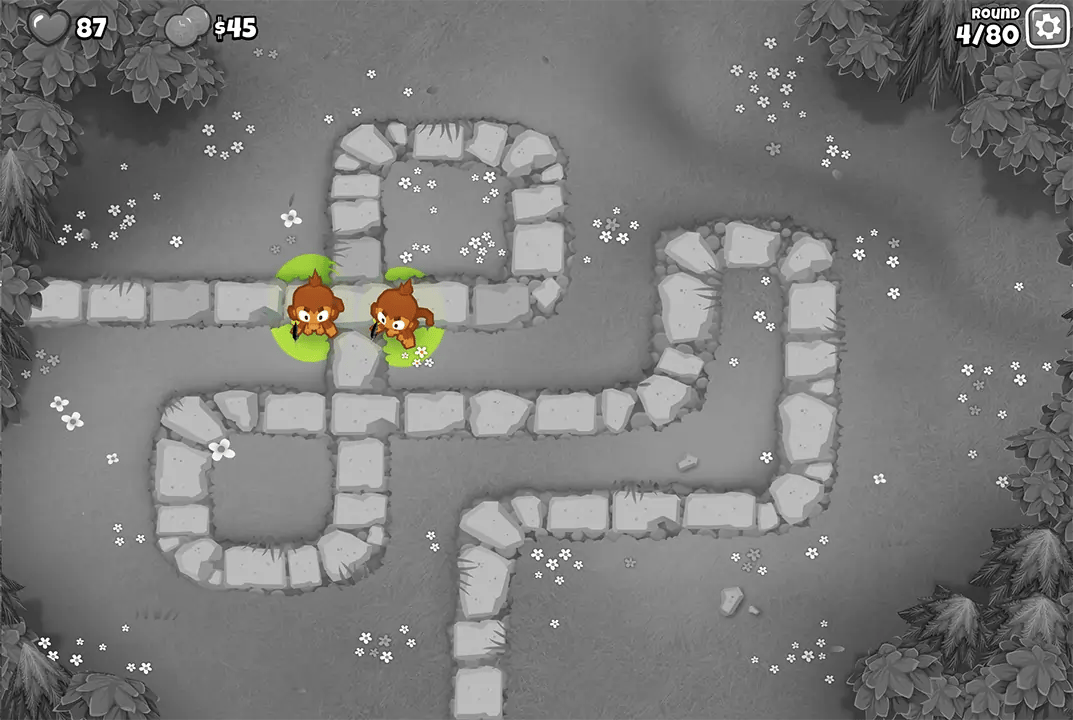 Bloons TD 6 screenshot of Round 4 on Monkey Meadow for Half Cash mode. Two Dart Monkeys are defending the path early in the game, with the player's life count at 87 and minimal funds available.