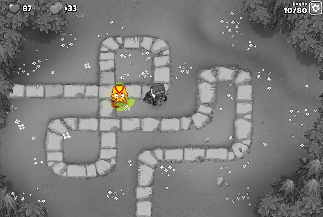 Bloons TD 6 screenshot of Round 10 on Monkey Meadow for Half Cash mode. The Boomerang Monkey is defending the path alongside Quincy, showing the progress in setting up the defense.