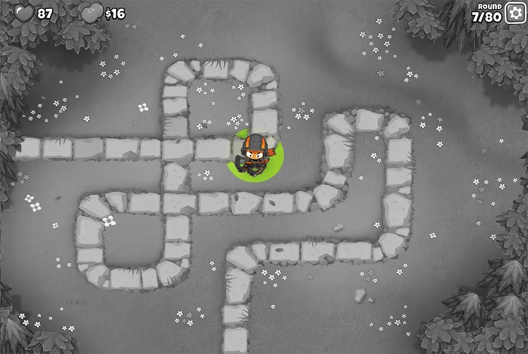 Bloons TD 6 screenshot of Round 7 on Monkey Meadow for Half Cash mode. Quincy is present on the path, continuing the early game defense with the player's life count at 87.