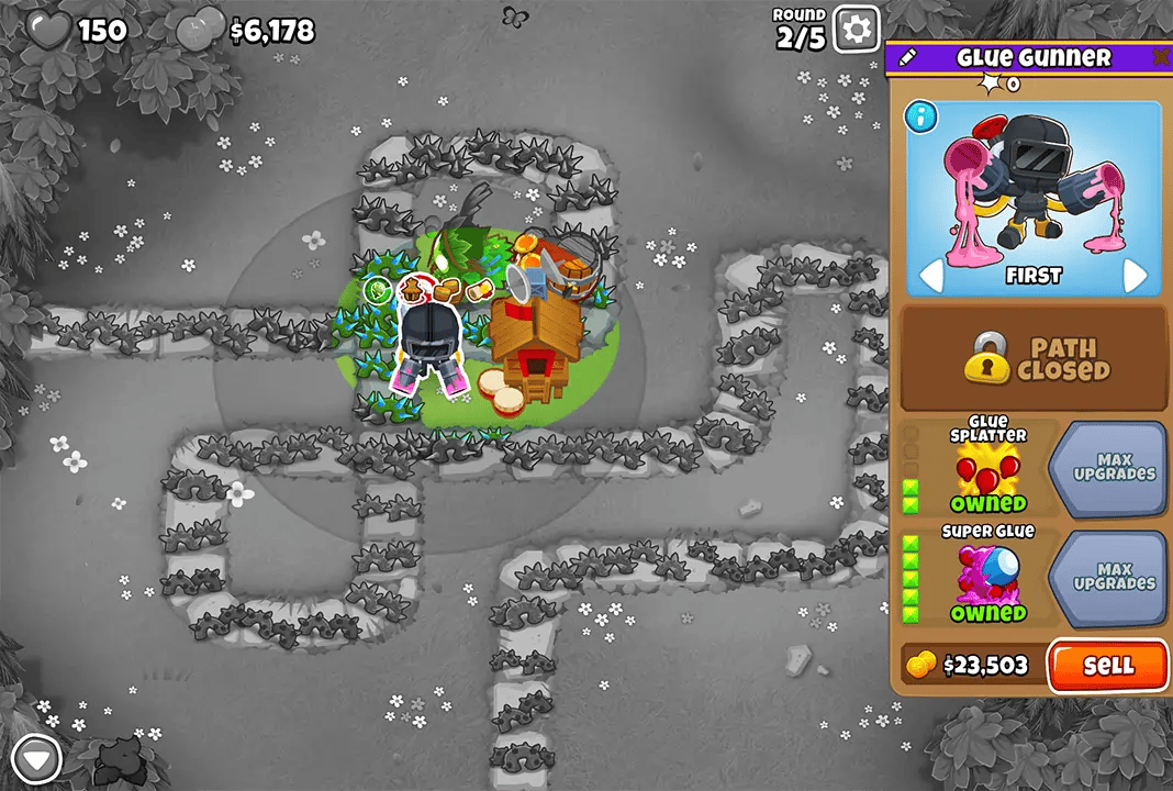 BTD6 game screen showing Round 2 with a Glue Gunner and Monkey Village placed on the map. The upgrade menu for the Glue Gunner is open, showing Glue Splatter and Super Glue upgrades.