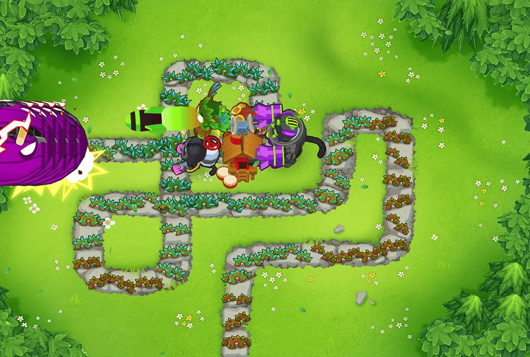 BTD6 game screen showing a full tower setup with a Druid, Alchemist, Glue Gunner, Monkey Village, and Dartling Gunner placed on the map. The towers are actively engaging a large purple MOAB-class bloon approaching from the left side of the screen.